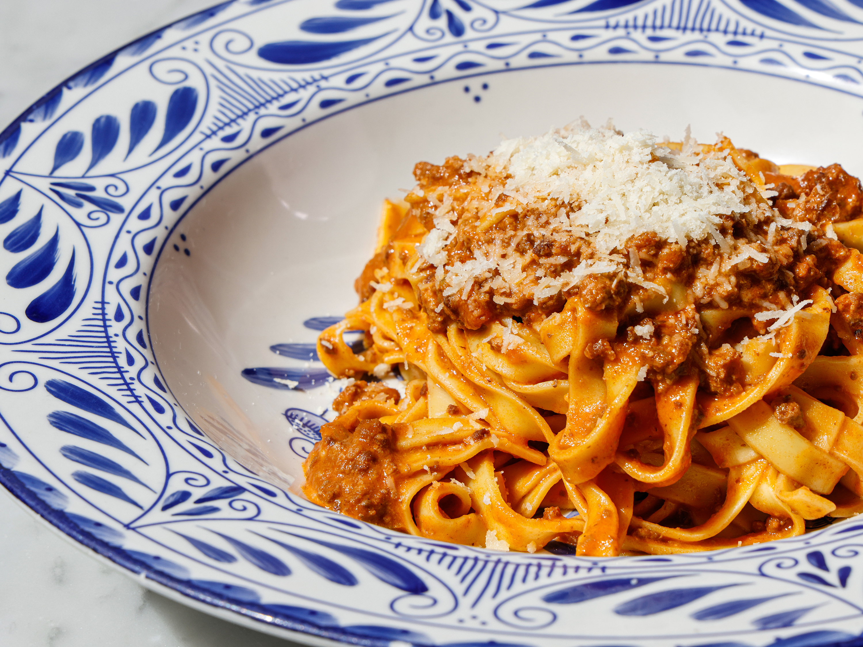 Handmade tagliatelle coated in rich Bolognese sauce and finished with Parmesan. 