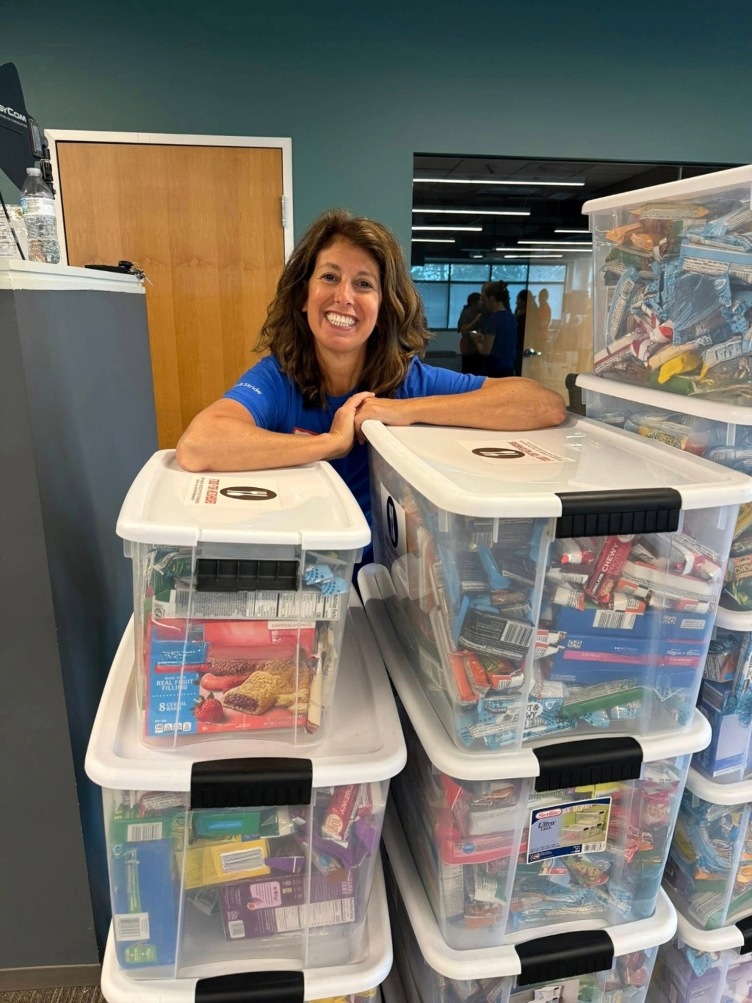 Christine Angles, VA Car Insurance Allstate Agent, volunteering for Food For Neighbors to pack food for local students facing food insecurity.