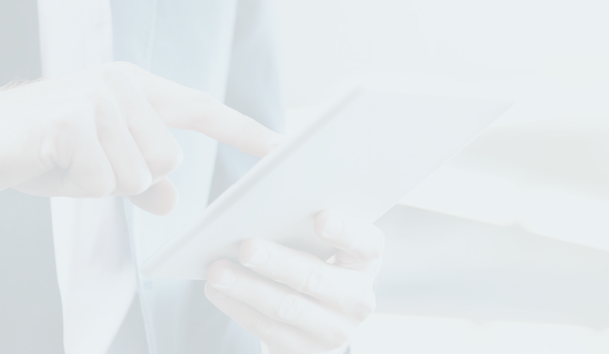 Close-up of a person in business attire using a tablet.