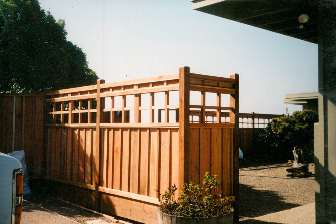 Custom wood fence and gate installation providing privacy, security, and convenient access for a residential property.