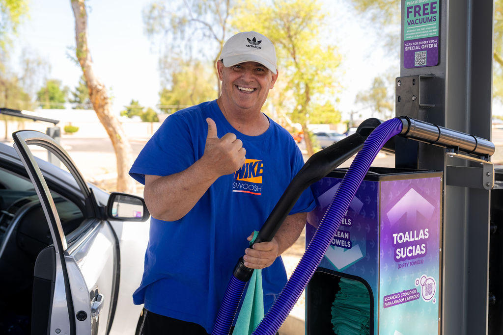 Customer enjoying the complimentary vacuum amenities at DASH Car Wash Olive Ave. 