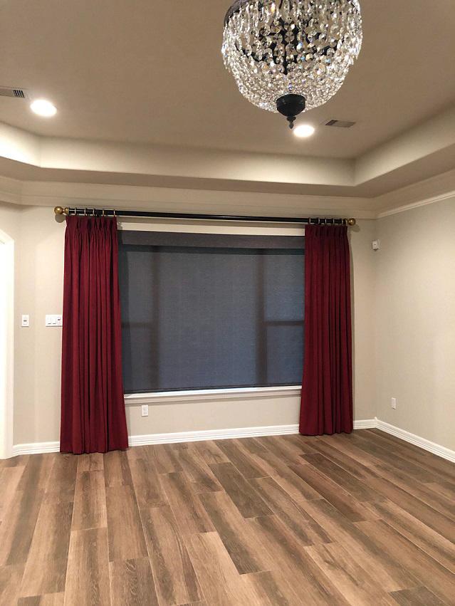 Custom Blackout Drapery Panels on a black rod with gold finials by Budget Blinds of Katy and Sugar Land help to bring a touch of modern class to this newly renovated home in Richmond, TX!