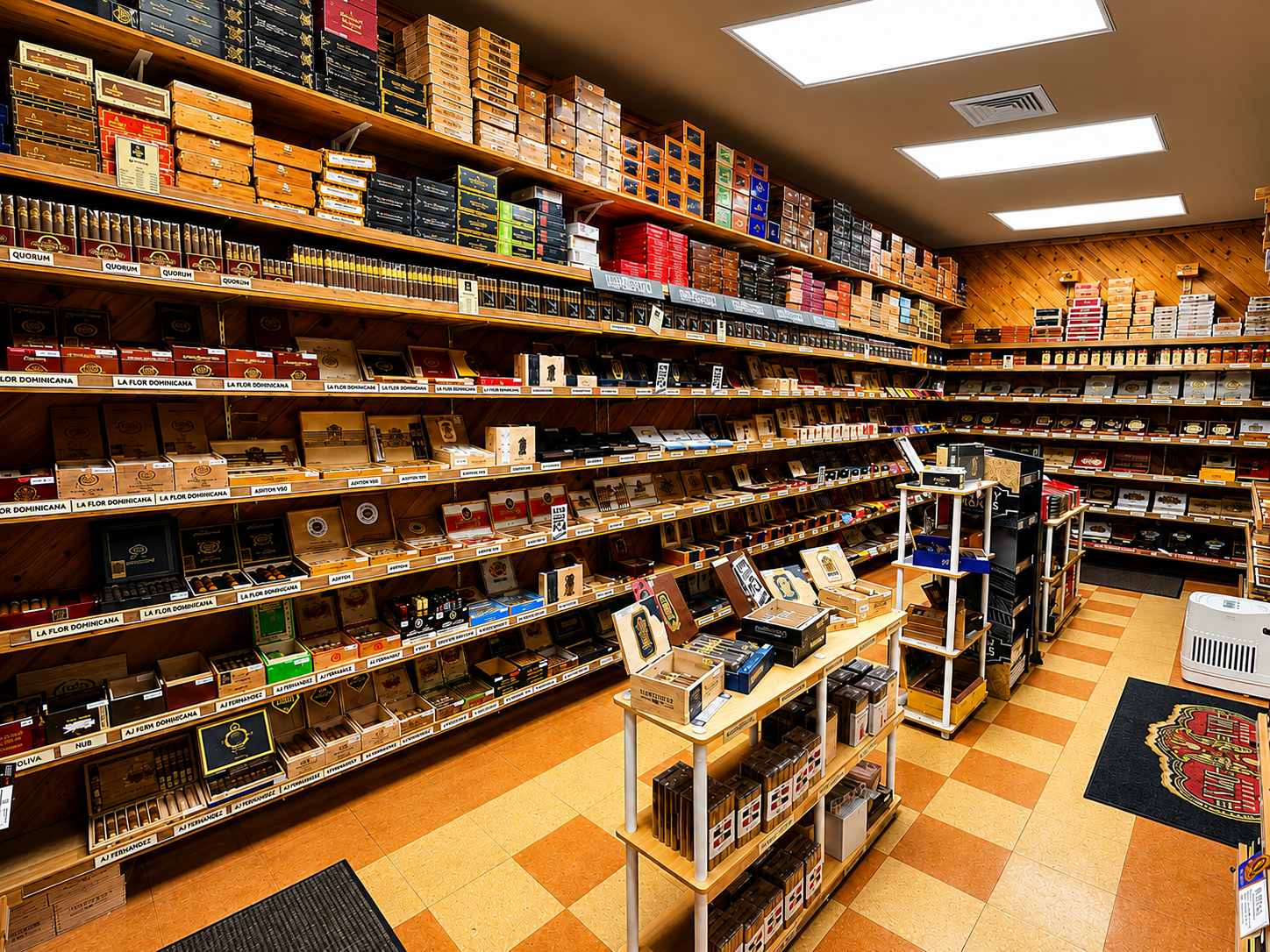 Explore the premium cigar selection at Tom Trella, featuring a well-organized humidor with a wide variety of handcrafted cigars and top-quality tobacco products. The clean, spacious retail interior makes it easy for customers to browse their favorite brands and discover new selections in a welcoming shopping environment.