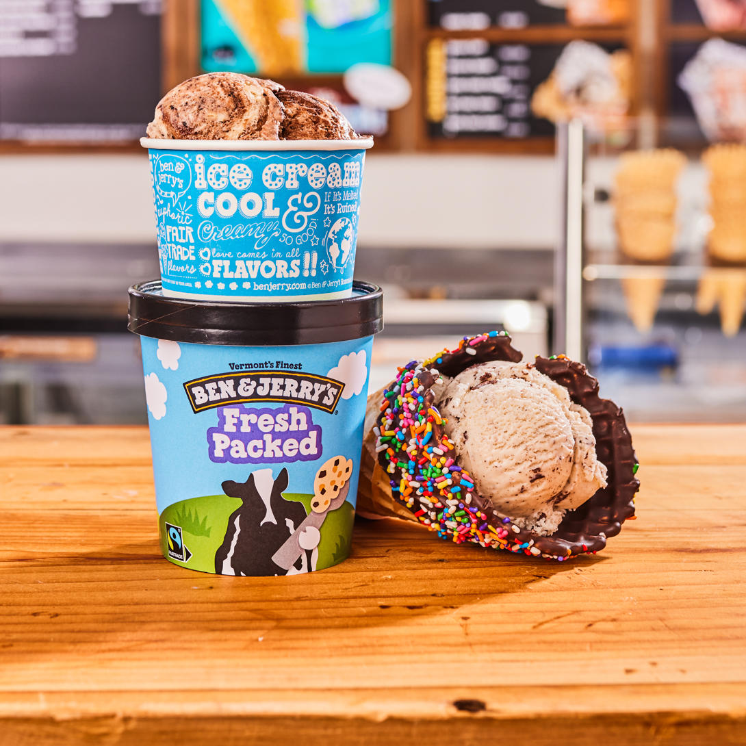 Waffle cone, cup and fresh packed pint in front of Ben & Jerry's ice cream shop menu board. Ben & Jerry's Noosa Heads (07) 5447 4803