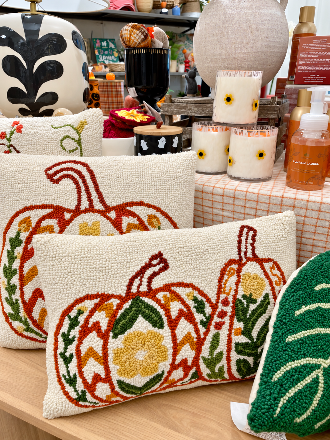 Welcome autumn with textured pumpkin pillows, floral candles, seasonal soaps, and decorative accents 