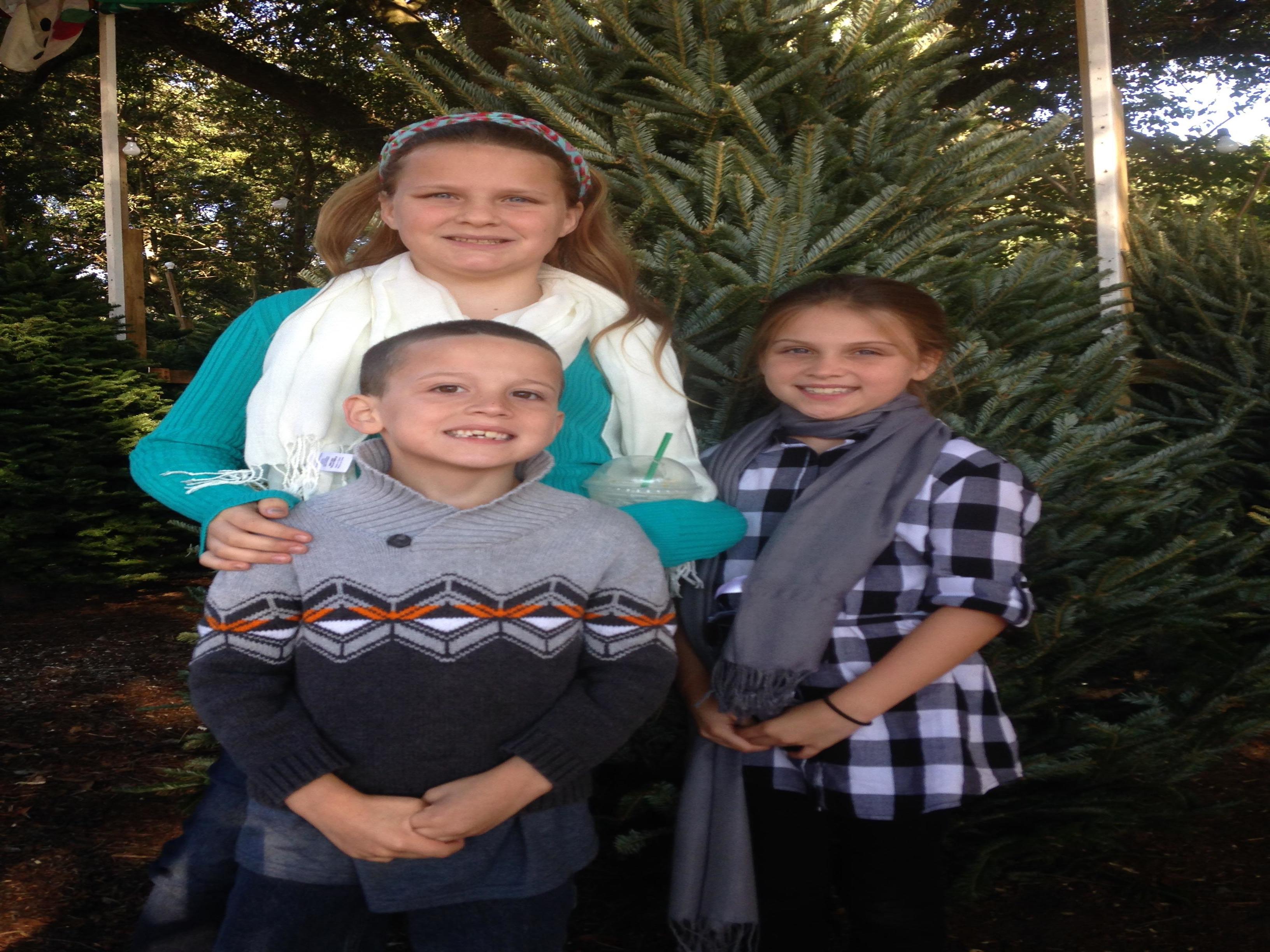 3 children - in front of a Fraser fir- Christmas tree