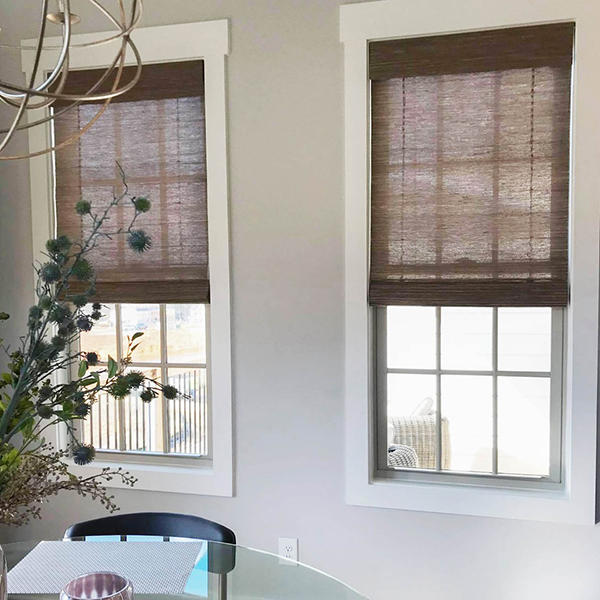 Woven wood shades offer texture and contrast to your home design. Here they help to provide variety to this neutral sitting room while matching the darker tones of the furniture.