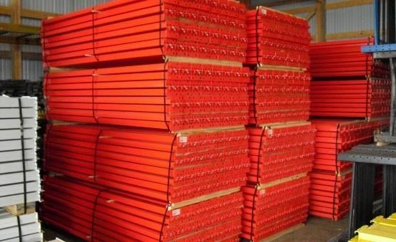 Pallet rack cross beams stacked in warehouse inventory.