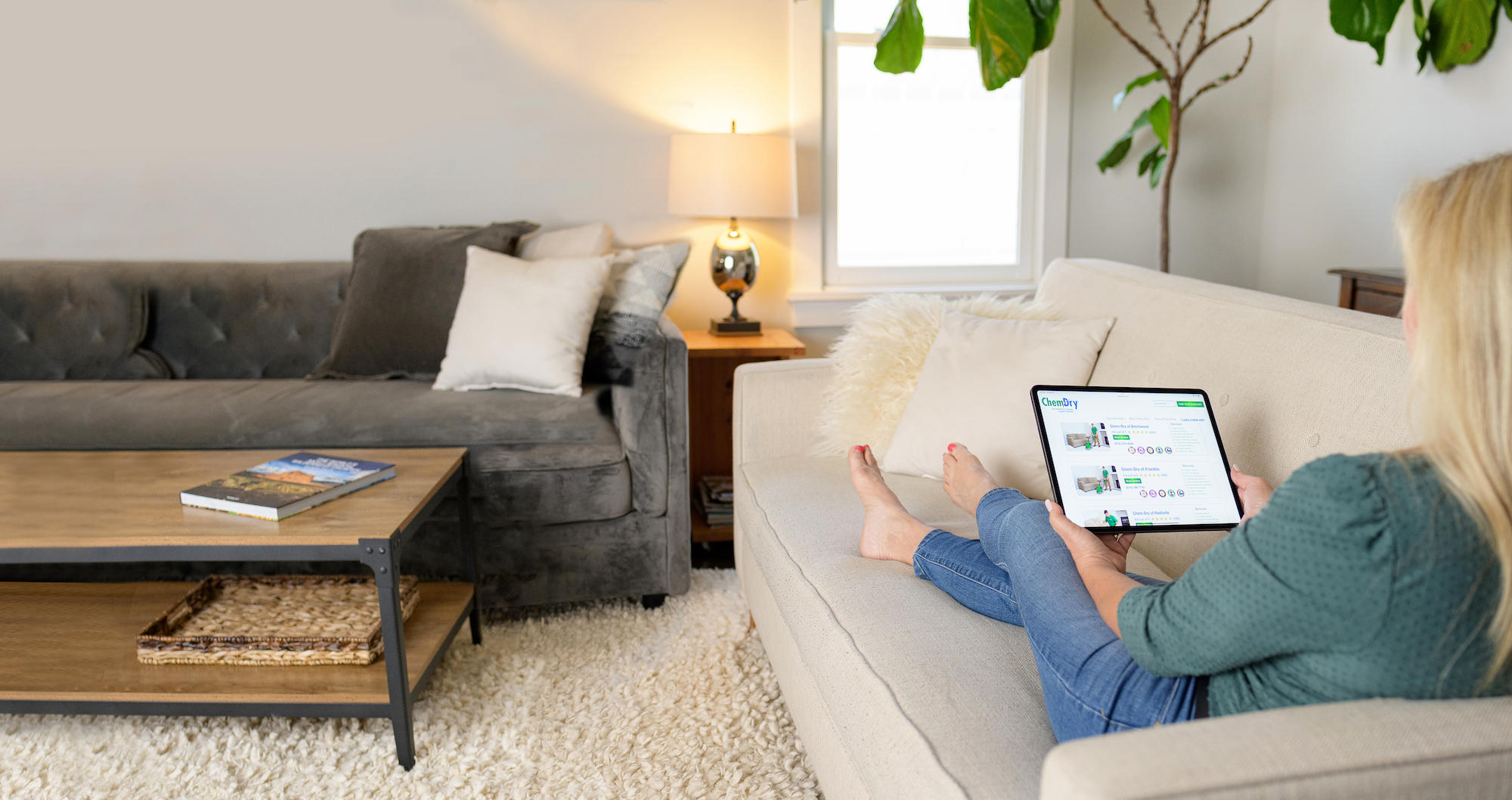 Woman sitting on clean furniture with a tablet