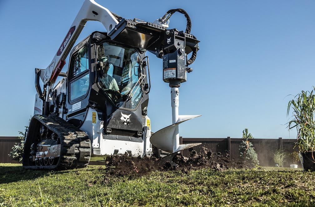 Bobcat S590 skid-steer loader uses planetary auger attachment to dig fence posts. Bobcat of Lima Bellefontaine (937)595-5050