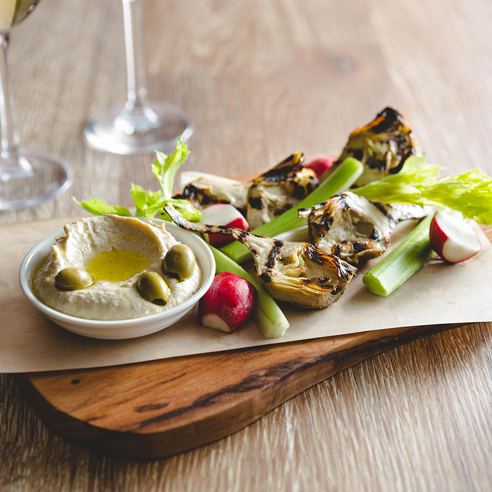 Grilled Artichokes with Preserved Lemon Hummus—celery hearts, radishes, crispy lavash, green olives