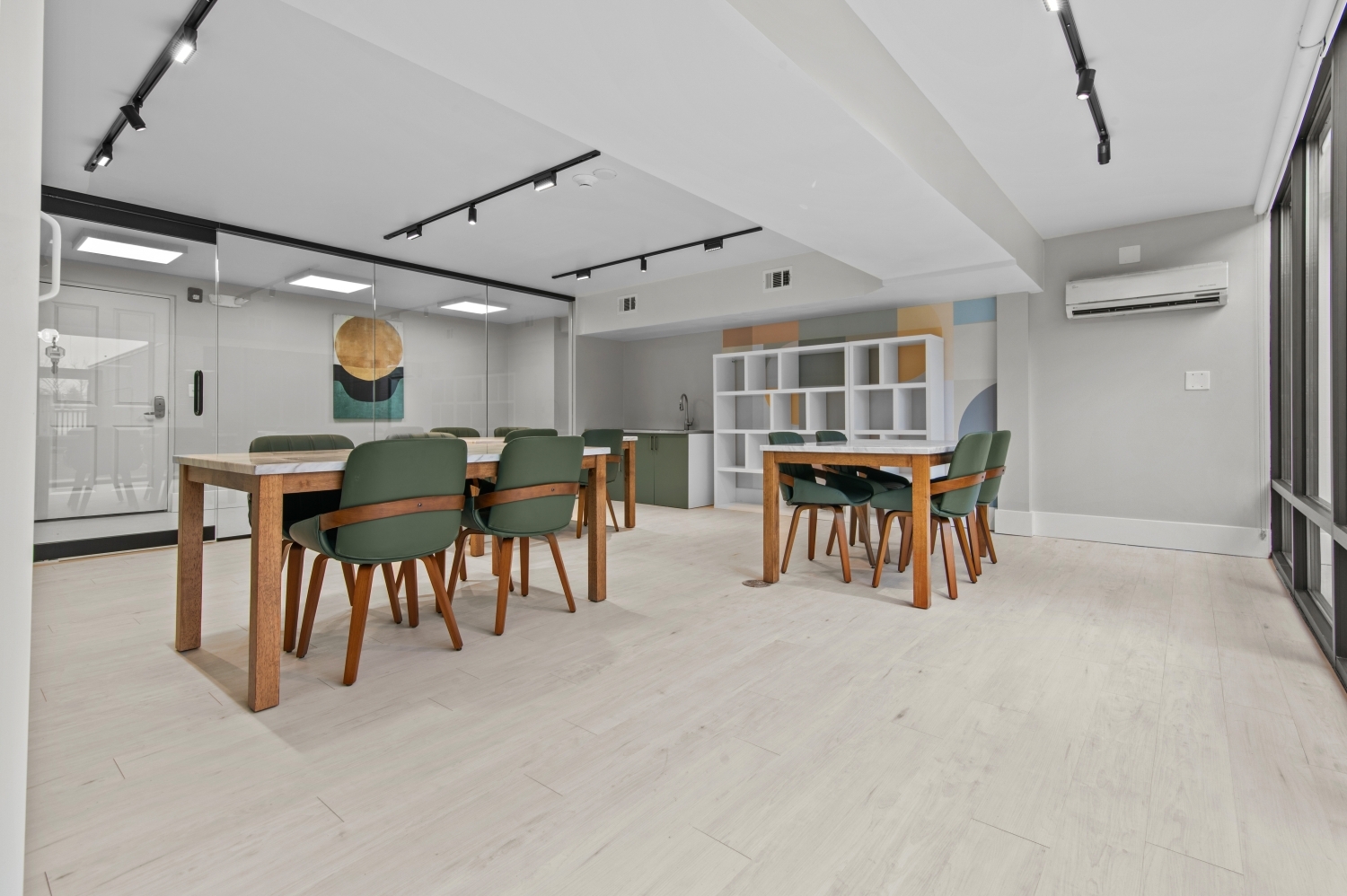 This image showcases a modern resident meeting and activity space at Solaire Senior Living in Southfield, MI, designed to provide a comfortable place for residents 62 years of age and better to gather, socialize, and participate in community programs. The bright and inviting room features contemporary furnishings, spacious seating areas, and a welcoming atmosphere ideal for small group activities, games, and community events. As part of this luxury senior apartment community, these shared spaces encourage connection and enhance everyday living.