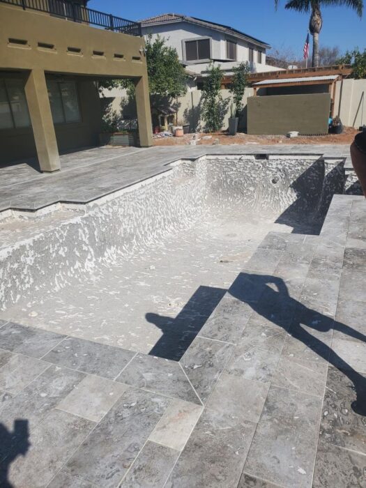 An existing swimming pool during the demolition and preparation phase of a remodel. Removing deterio 