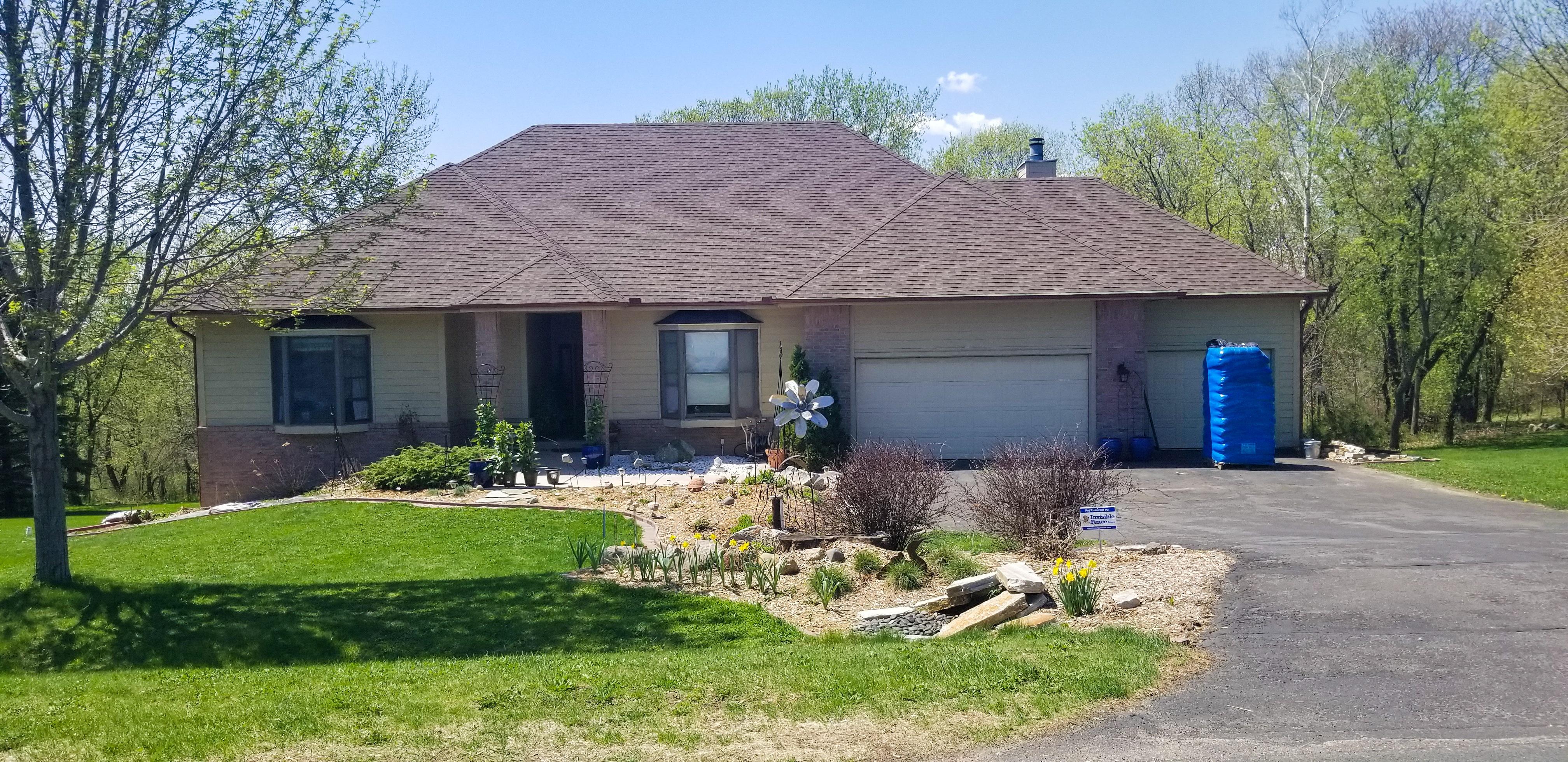 Custom seamless gutters installed on the front of a residential home by Ultimate Gutter Solutions.