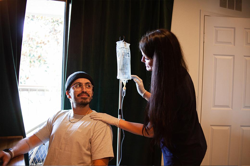 Man receiving IV therapy at home in Los Angeles from a mobile IV nurse