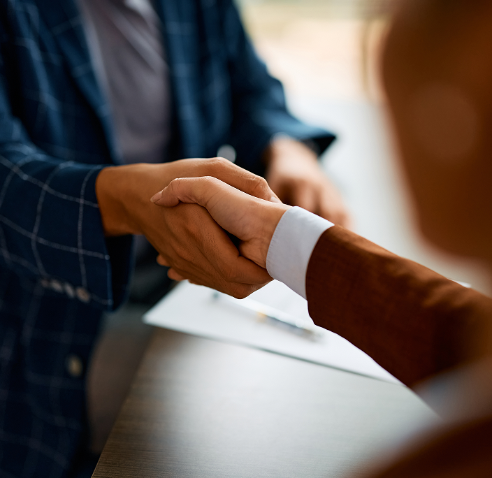 Close up of two people shaking hands.