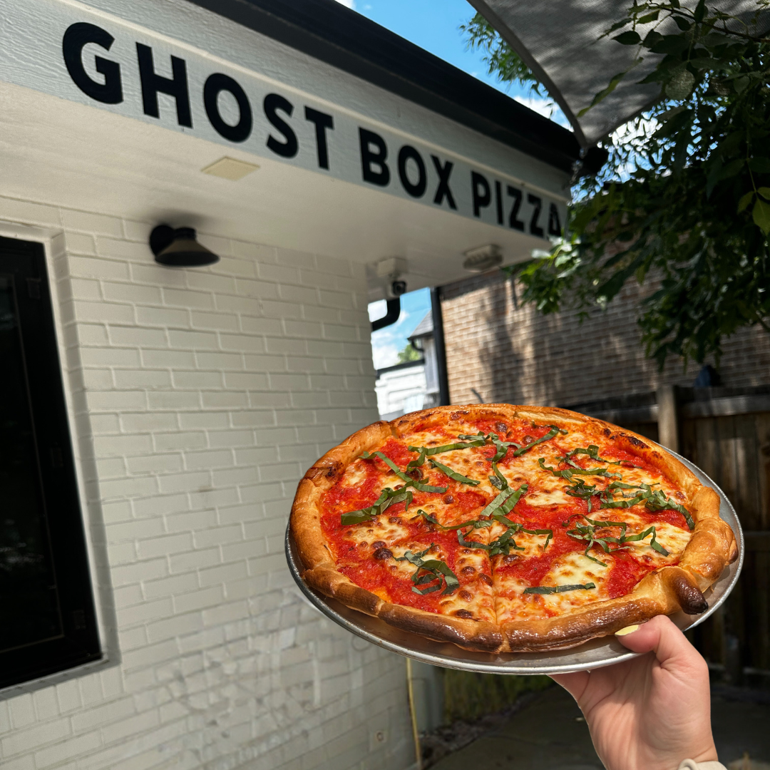 A handcrafted pizza highlights the quality ingredients and bold flavors that define the Ghost Box Pizza experience.
