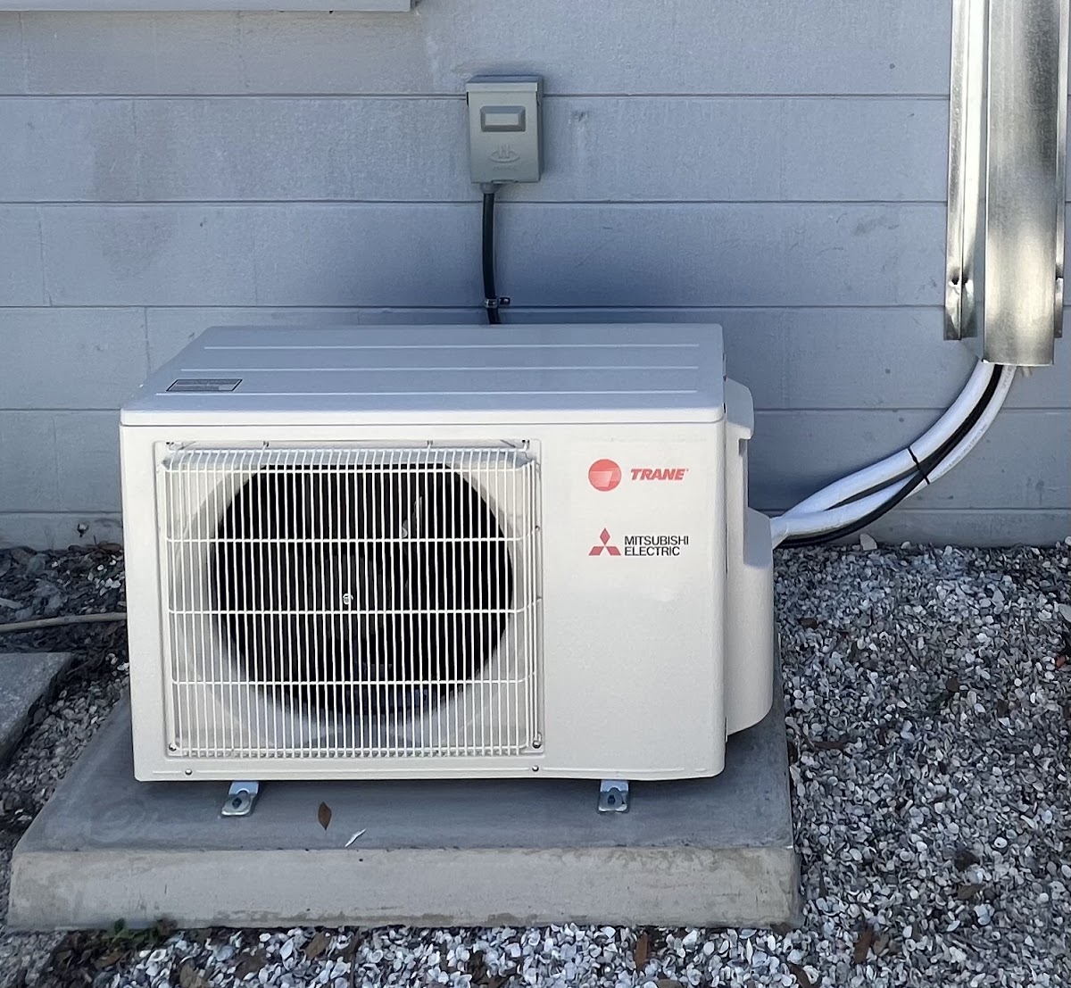 Mitsubishi ductless mini-split outdoor condenser installed for reliable, high-efficiency heating and cooling performance.
