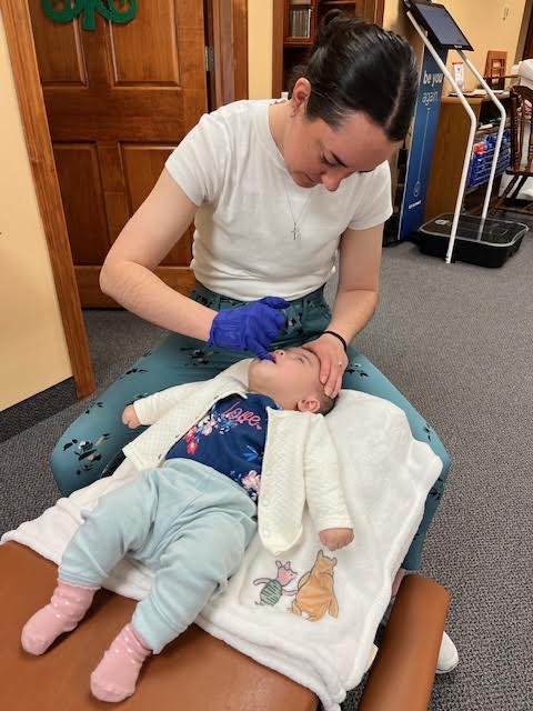 Dr. Montana Belford adjusting an infant at Prior Lake Chiropractic