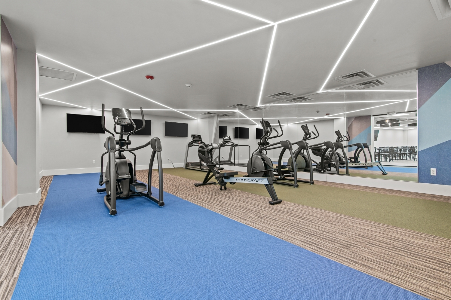 This image highlights the modern fitness center at Solaire Senior Living in Southfield, MI, designed to support an active and healthy lifestyle for residents 62 years of age and better. The bright, spacious workout area features cardio equipment, mirrors, and comfortable flooring that make it easy for residents to stay active in a welcoming environment. As part of this luxury senior apartment community, the fitness center provides a convenient way for residents to maintain wellness while enjoying the comfort and serenity of Solaire.