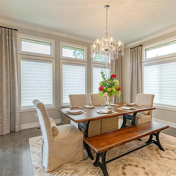 These drapery panels really bolster the elegant look of this dining room, matching the color scheme perfectly. For light-filtering, opt for shades, which allow soft light to enter and illuminate the space.