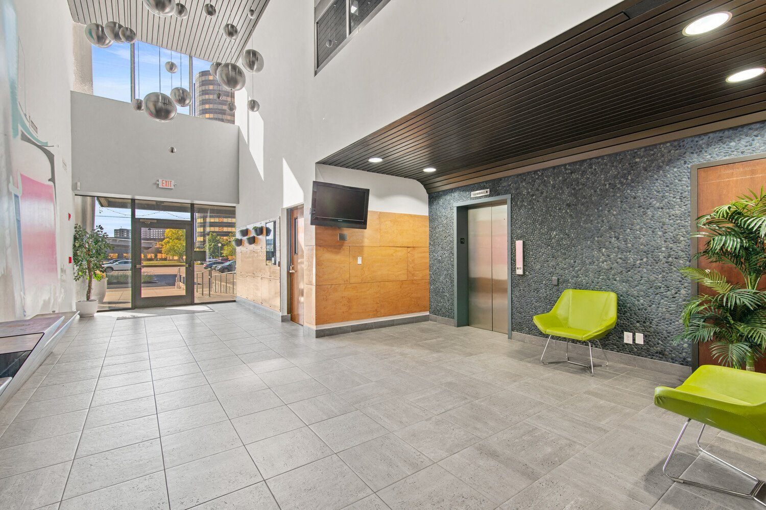 a lobby with a door and a television in a building