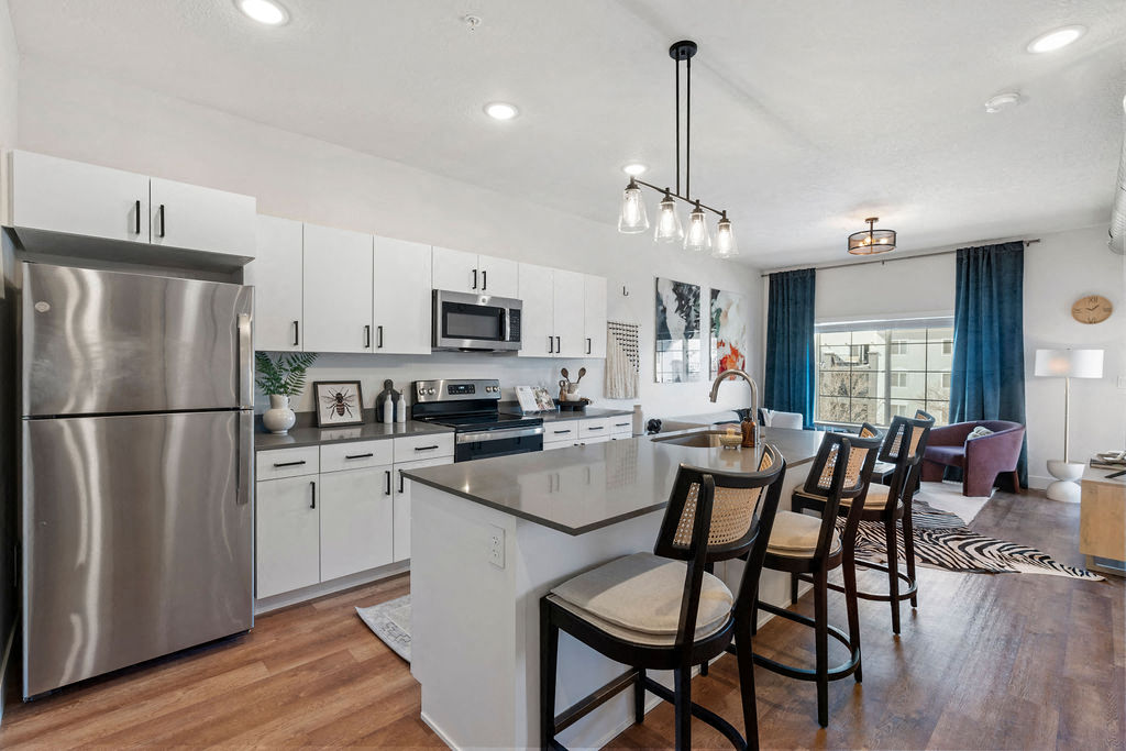 an open kitchen and dining area with a large counter top