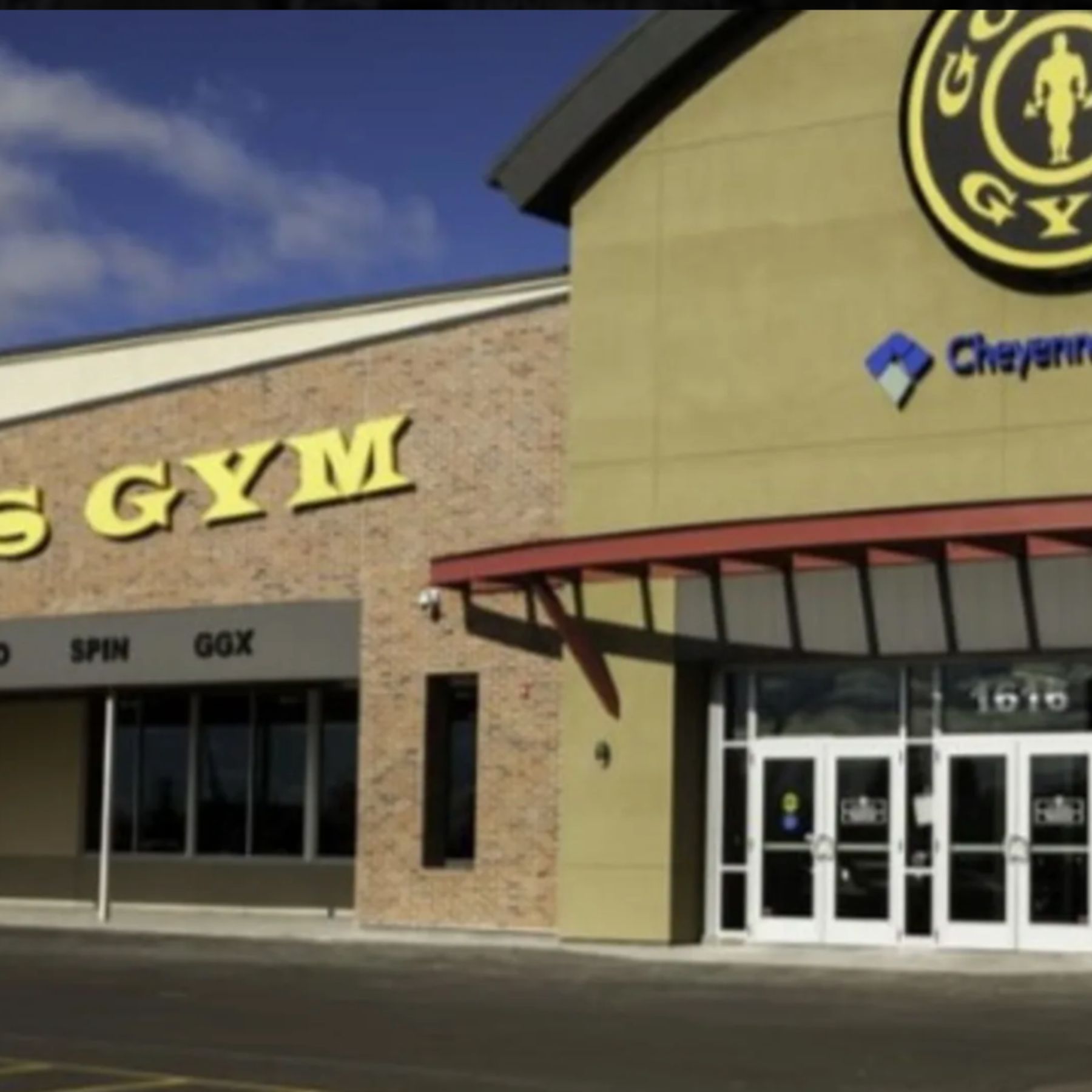 The exterior of our Cheyenne gym features the main entrance beneath the iconic Gold's Gym logo, with large front windows and prominent signage. The building's modern storefront and welcoming entrance make it easy for members to find and access the club.