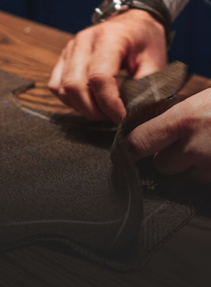 Close-up of a tailor's hands as he works on a suit.