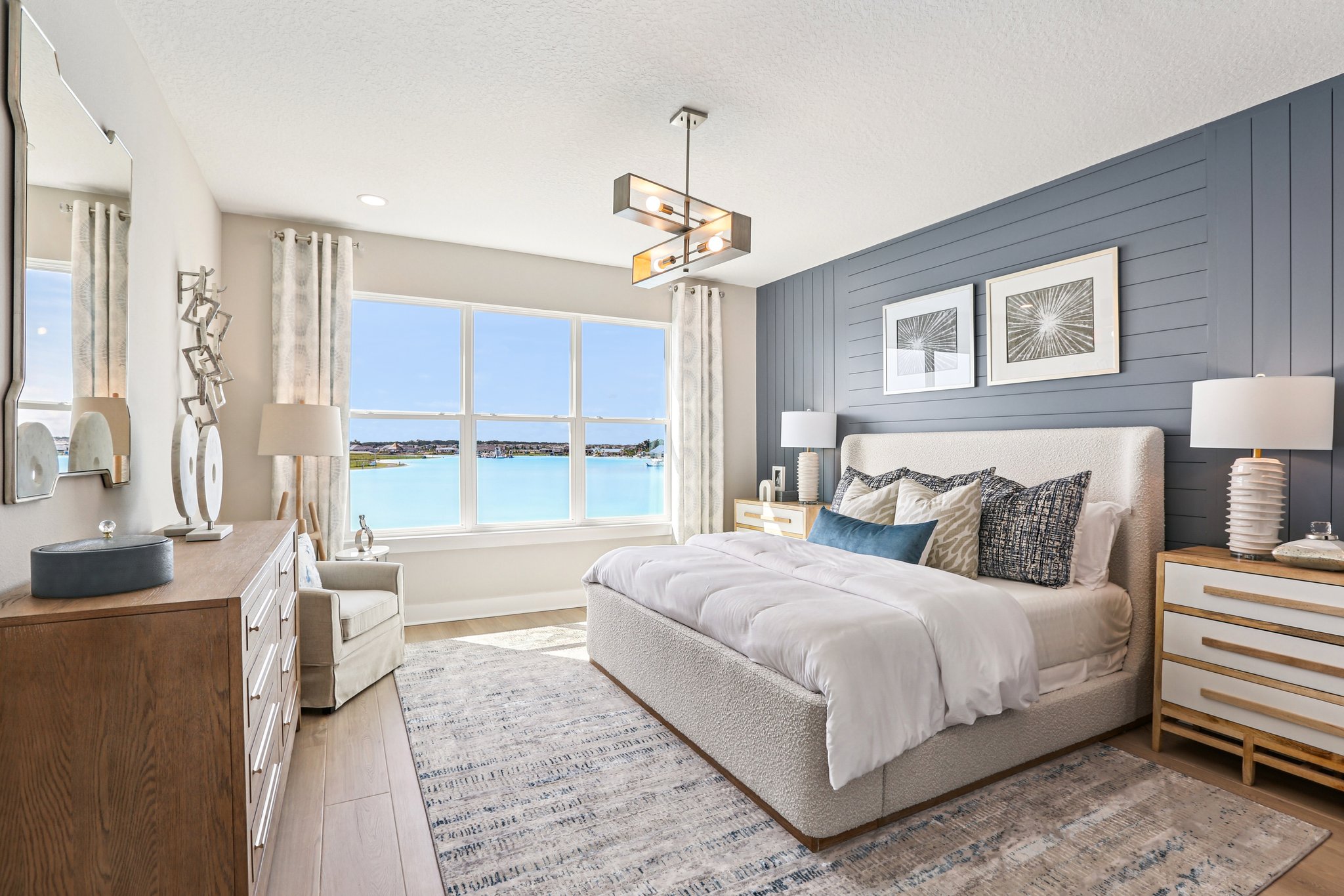 The Primary Bedroom with Mirada Lagoon Views of a DRB Homes Bimini Model at Isla Mirada in San Anton 