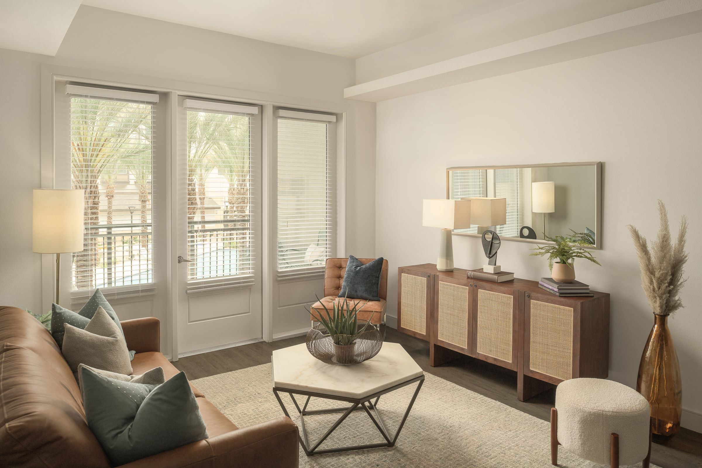 Living room with balcony access and wood-look floors at Camden Gilbert apartments in Gilbert, AZ