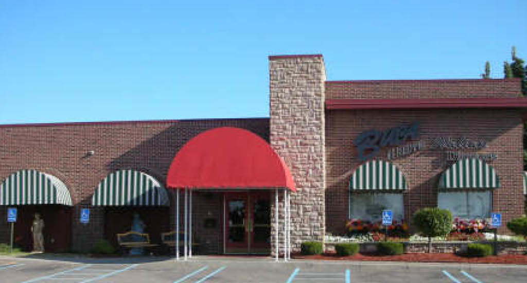 Brick Buca di Beppo restaurant front in Livonia with red, green, and white accents.