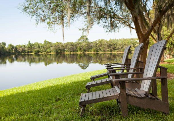Enjoy serene views of Lake Michelle from comfortable Adirondack chairs.