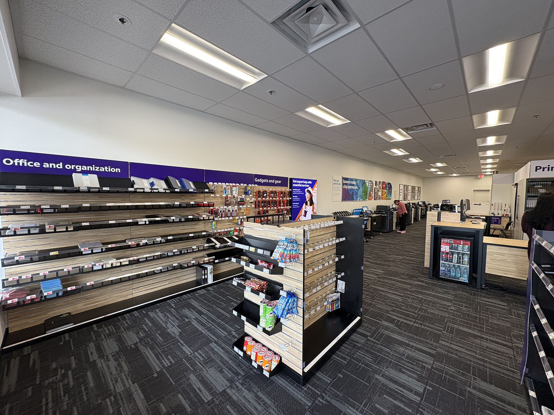 Retail and Office Supplies Section &ndash; Display shelves with office supplies, shipping materials, and packaging products available in-store.