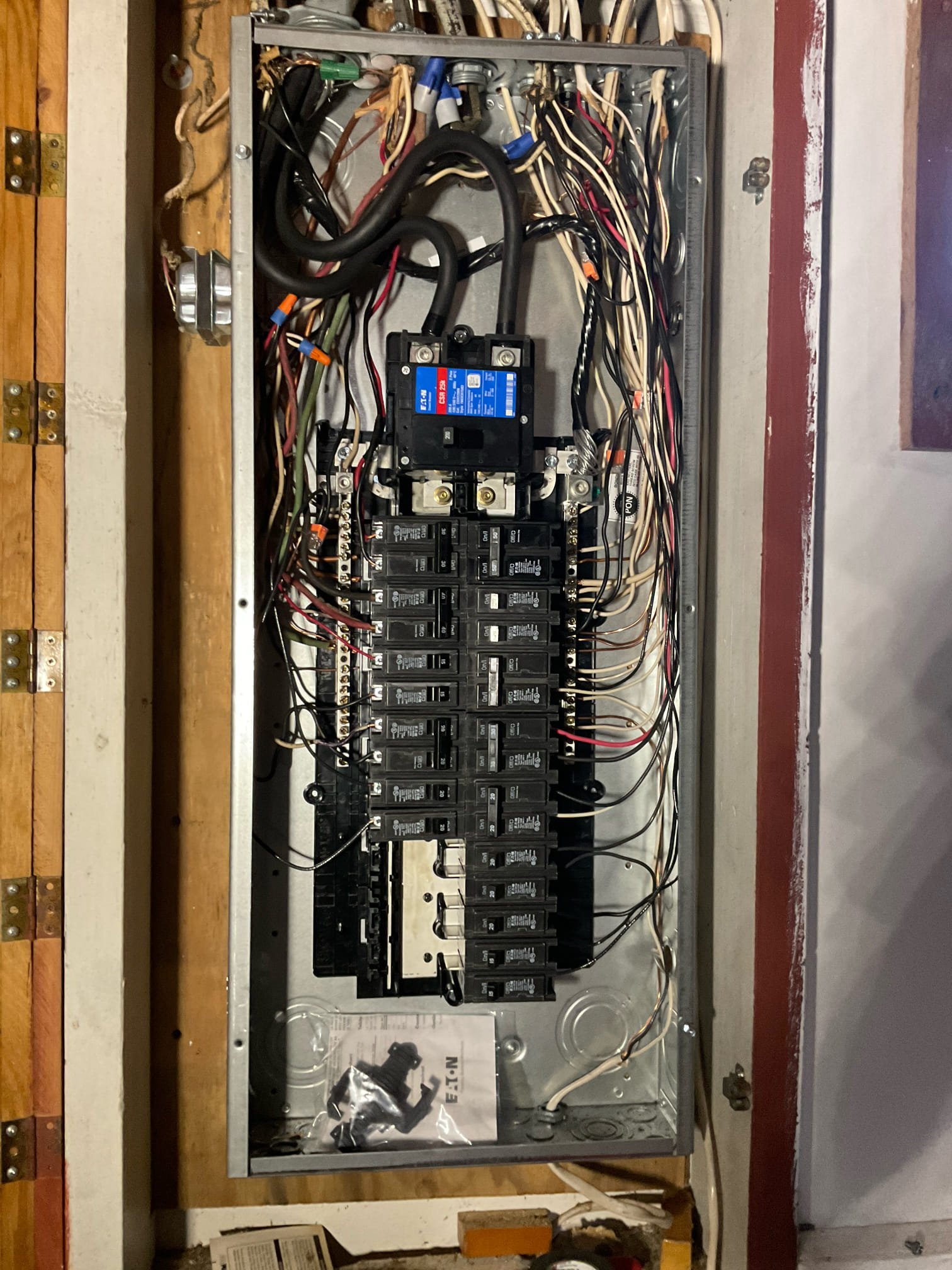 Thomas Edison Electric upgraded this residential Eaton breaker panel in a Norristown, PA home. The panel features a 200-amp main breaker with color-coded wiring and a full complement of circuit breakers, with Eaton branding visible at the base of the enclosure.