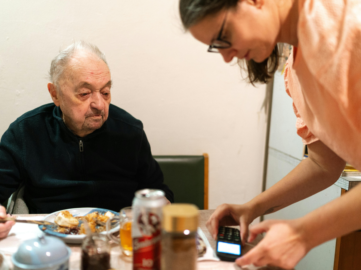 Caregiver assisting a senior with meal preparation and daily support in the comfort of their home.