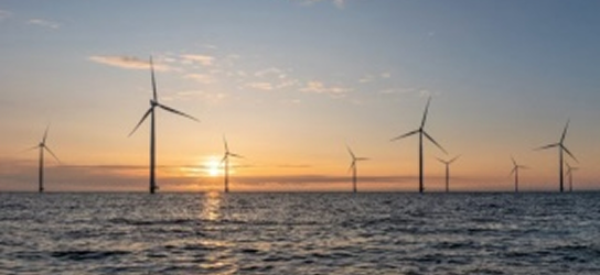 Offshore wind turbines at sunset.