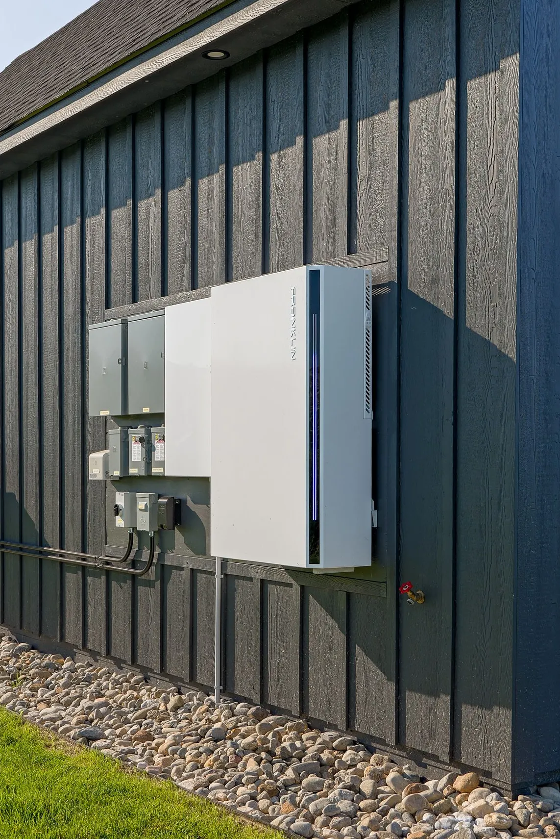 Residential battery backup storage system installed on an exterior wall