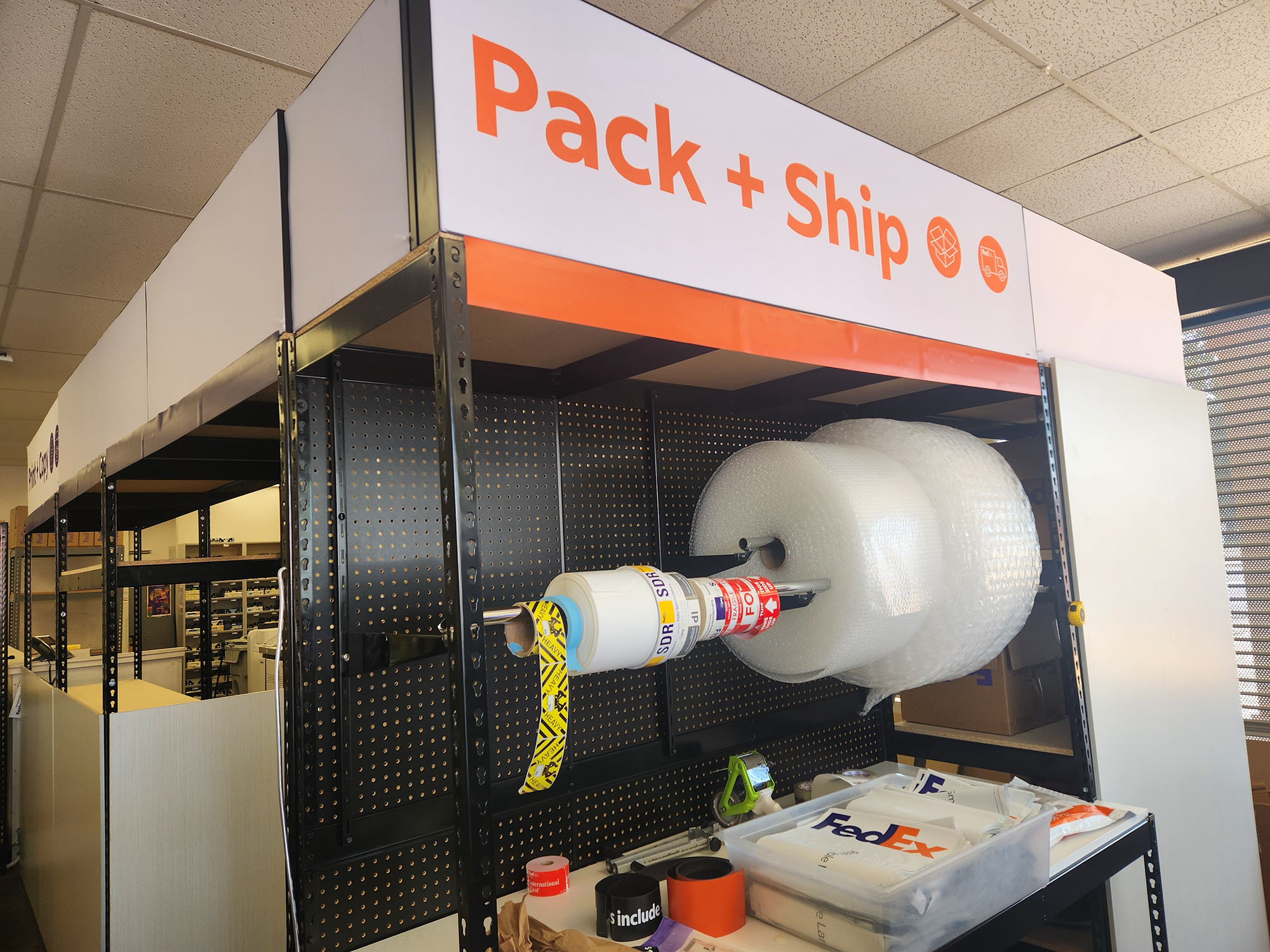 Pack and Ship Supplies Station &ndash; Packing supplies station with bubble wrap, tape, and shipping materials for secure packaging at FedEx Office Downtown Riverside.