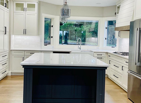 Custom kitchen remodeling project completed by Jason Smith Construction featuring a large center island, quartz countertops, custom white cabinetry, hardwood flooring, stainless steel appliances, and modern Northwest kitchen design in Clackamas County, Oregon. High-end kitchen renovation craftsmanship for homeowners in Canby, Wilsonville, Oregon City, West Linn, Molalla, and surrounding Northwest Oregon communities.