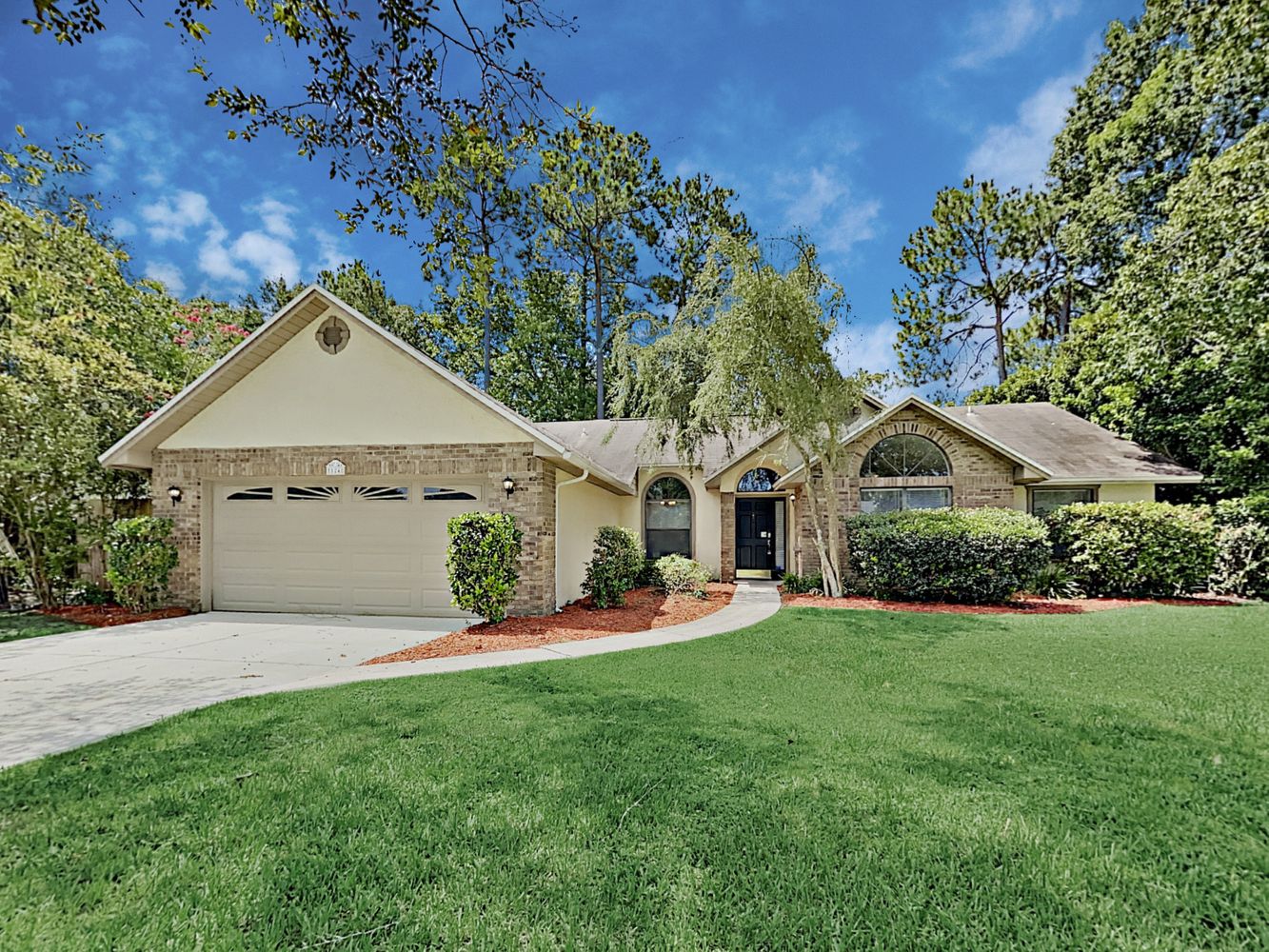 Beautiful home with a two-car garage and large lawn at Invitation Homes Jacksonville.