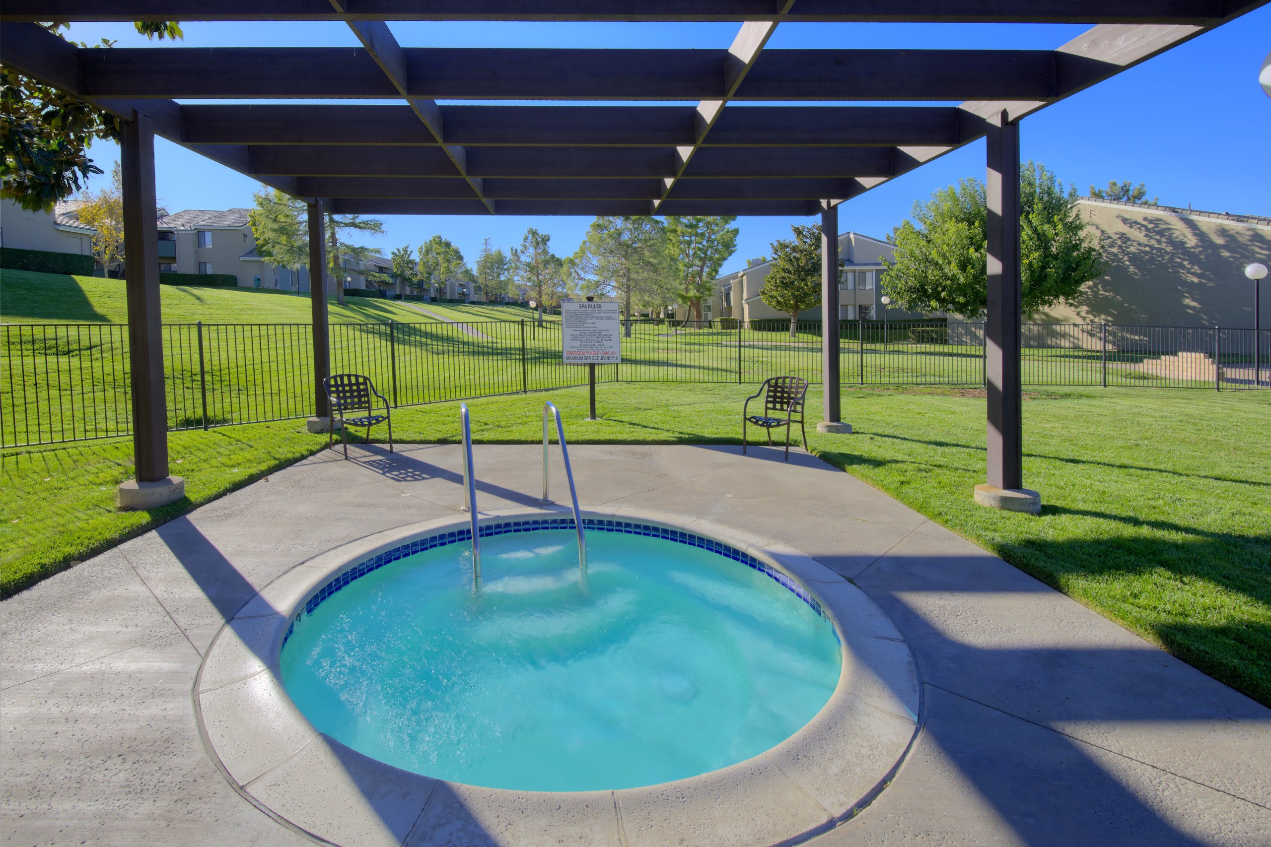 A small pool with a fountain in the middle of it.