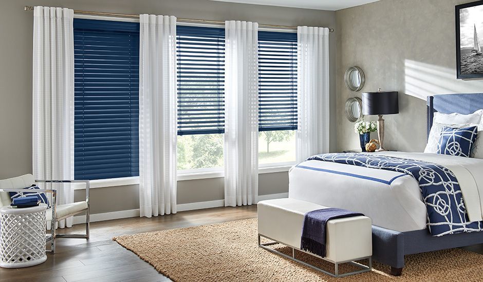 Add a pop of color to any space with custom Wood Blinds, accented with Drapery Panels, both by Budget Blinds to enhance the existing decor in your home of office!