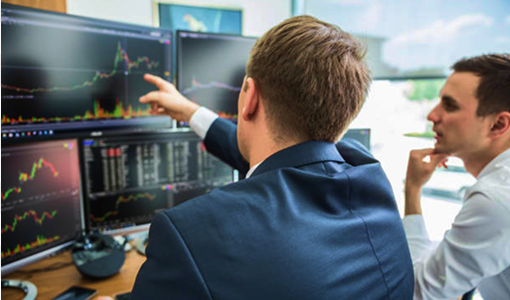 Advisors reviewing the markets on their computer screens.