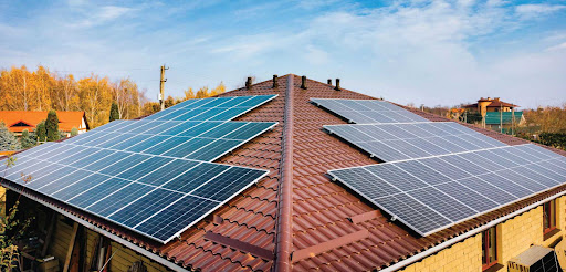 Residential rooftop photovoltaic system with multiple solar panel arrays installed across a tile roof, representing home solar energy systems serviced by SunWorx Solar Services.
