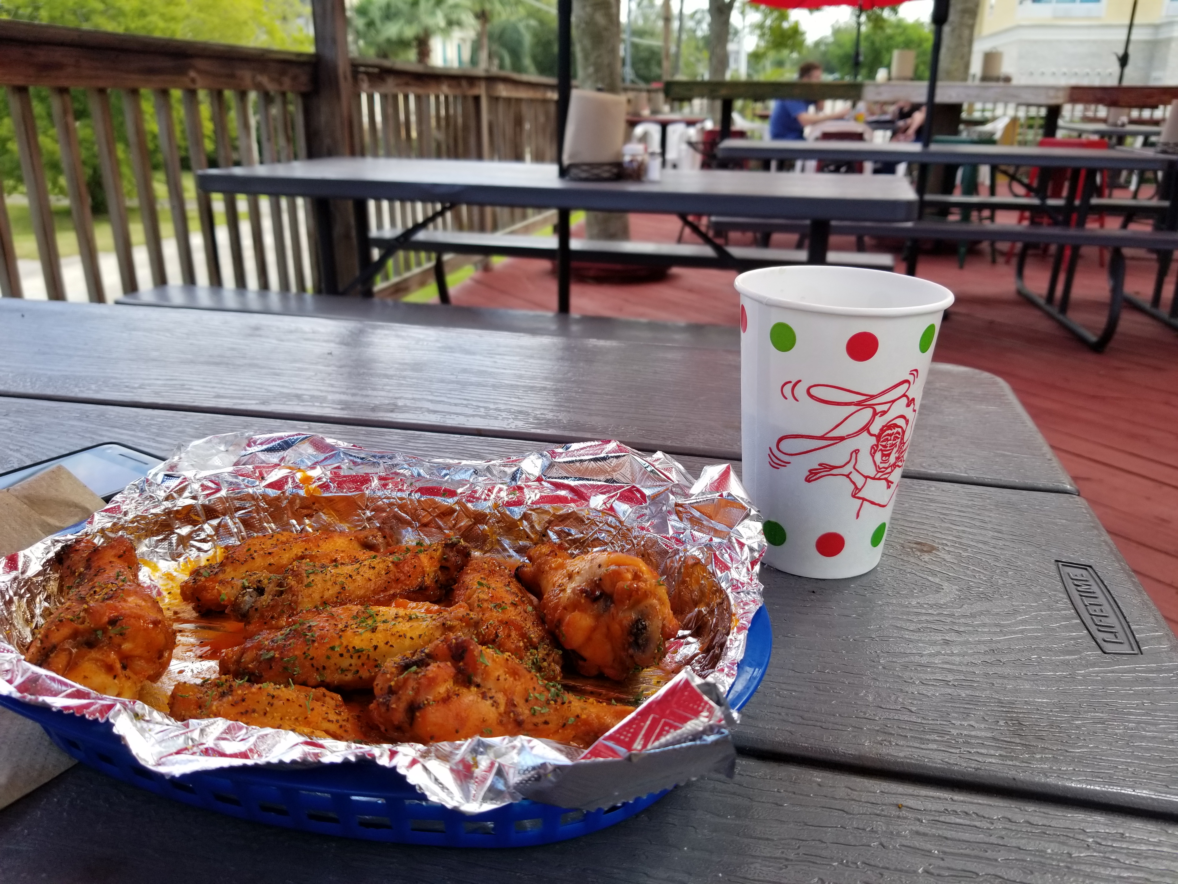 Delicious spicy lemon pepper wings with a cool cup of water on our beautiful and spacious deck!