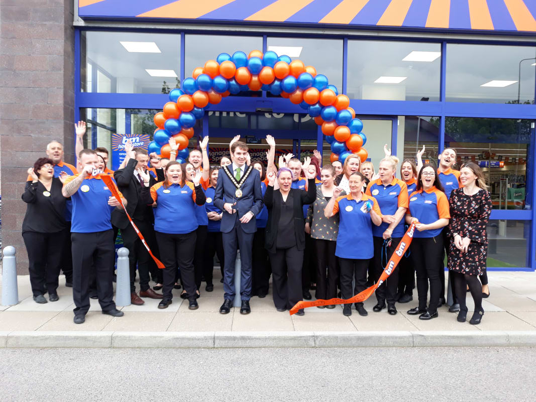 Posing outside B&M's new Home Store in Culverhouse Cross, Cardiff, Mayor Councillor Leighton Rowlands cuts the ribbon to officially decalre the store 'open'