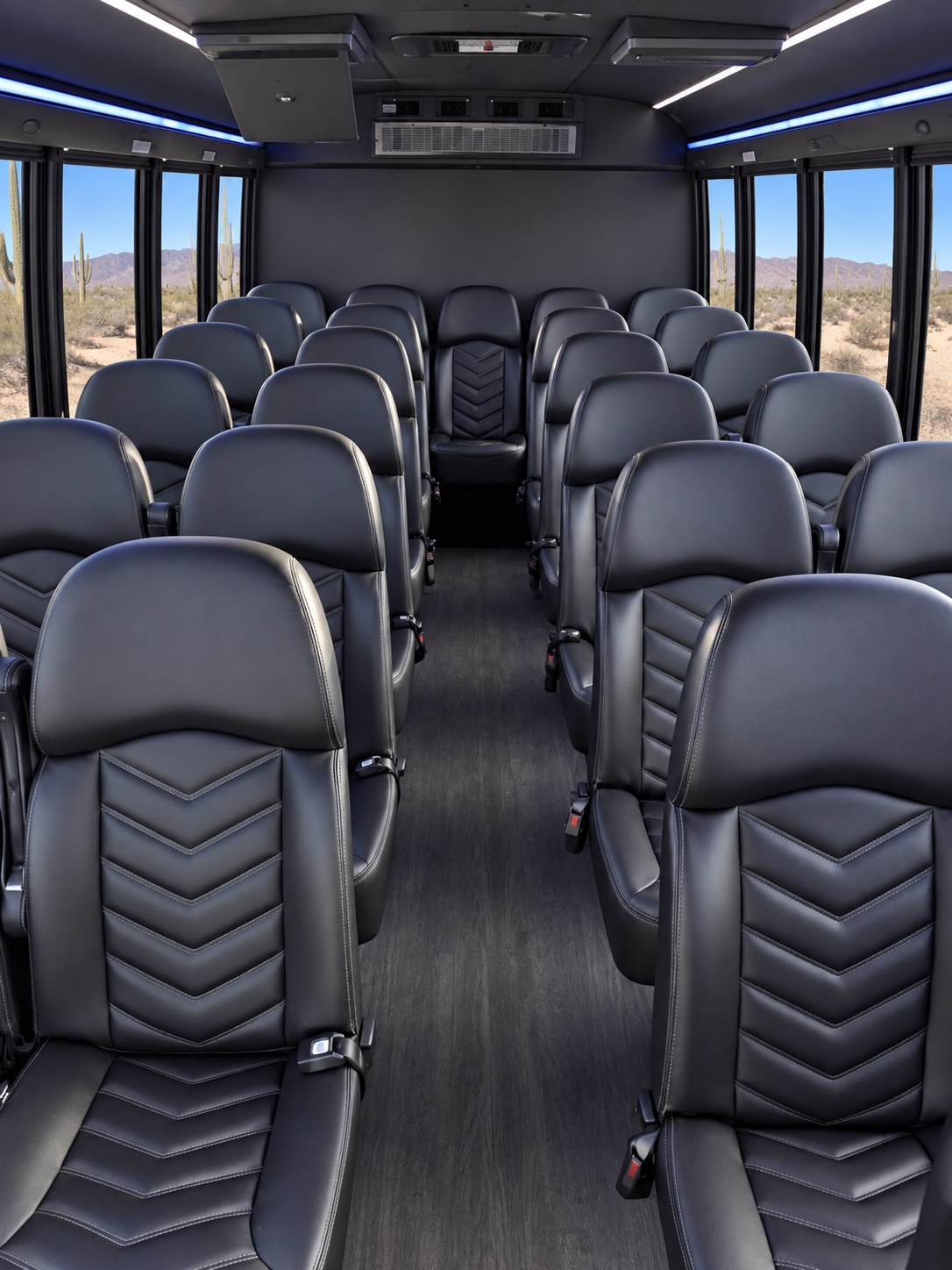 Spacious passenger shuttle interior with rows of comfortable black seats.