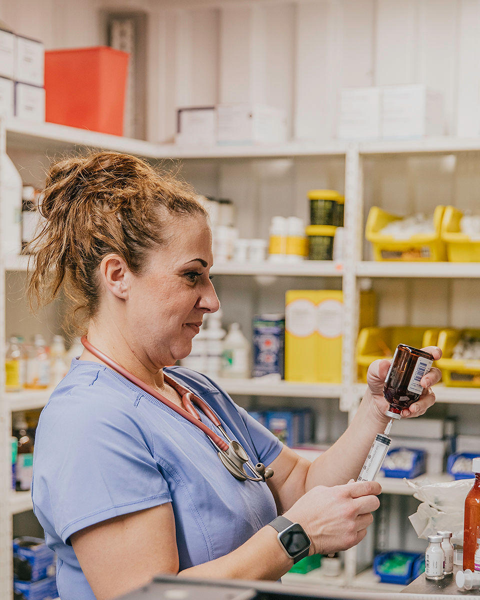 One of our technicians carefully draws up medicine for a patient.
