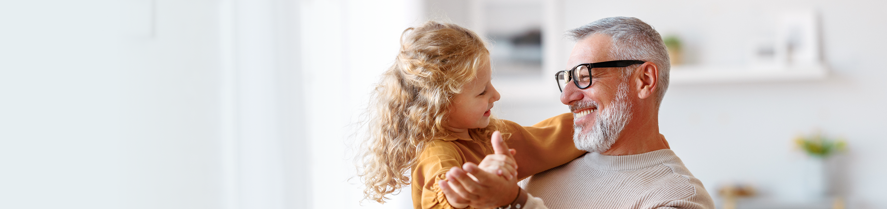 Grandfather dancing with his young granddaughter.